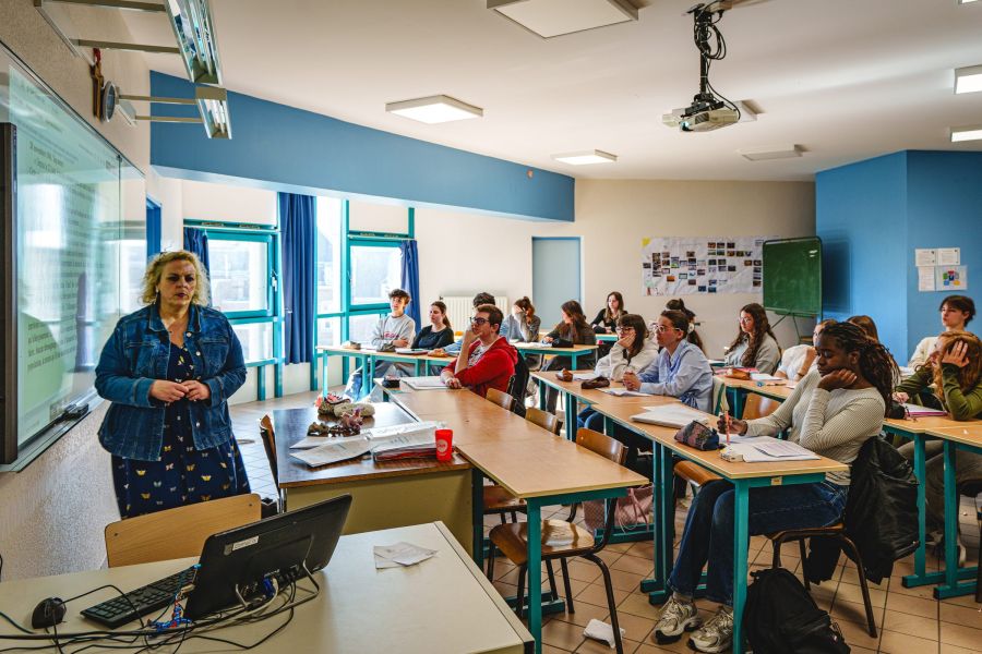 Élèves internes du lycée dans leur chambre, l'un révisant, l'autre lisant