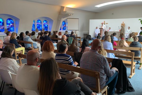Célébration religieuse réunissant élèves et familles dans une chapelle