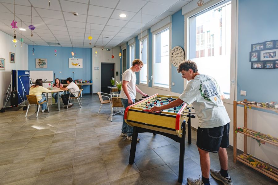 Internes jouant au babyfoot dans la salle de détente de l'internat