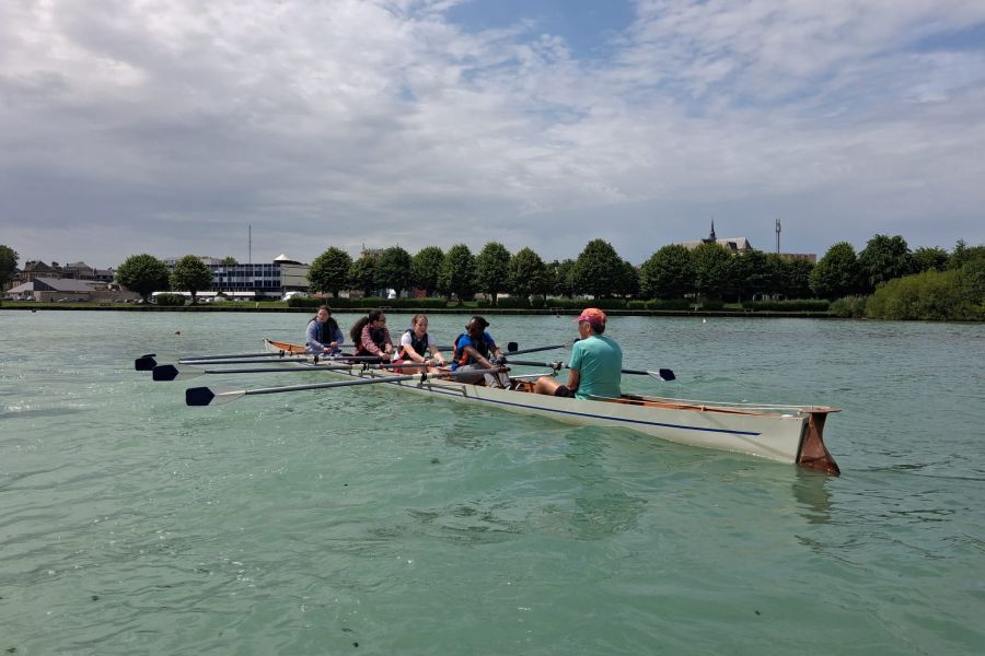 Équipe d'aviron en action sur l'eau lors d'une sortie de l'association sportive
